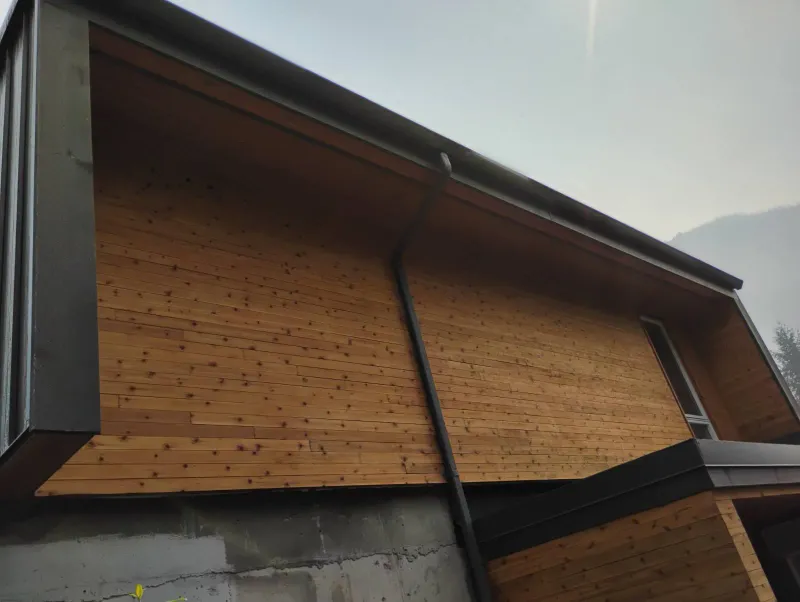 After: Upward view of freshly finished eave and siding soffit on the side of the house, . Arbour woods, Squamish, BC