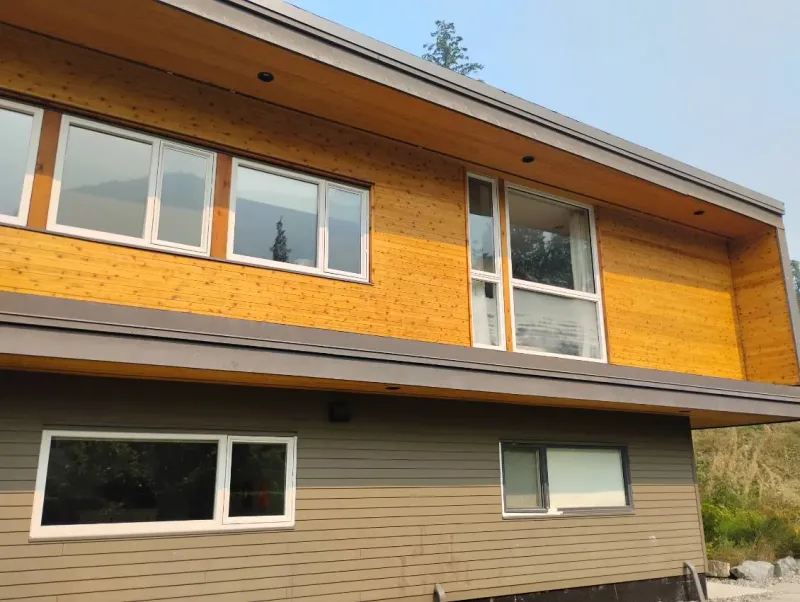 After: Upper level siding and windows on the side of the house with lower level siding below, . Arbour woods, Squamish, BC