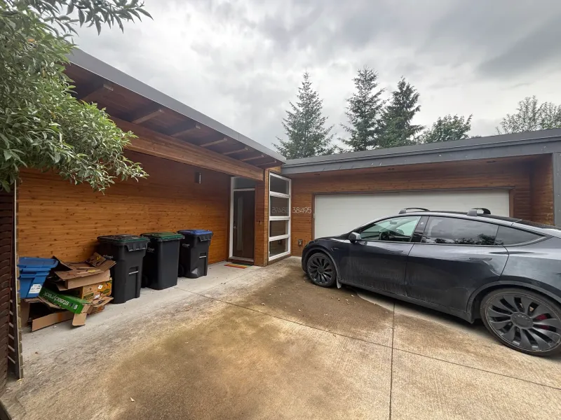 After: Front elevation of house with siding, entry door, and attached garage, . Arbour woods, Squamish, BC