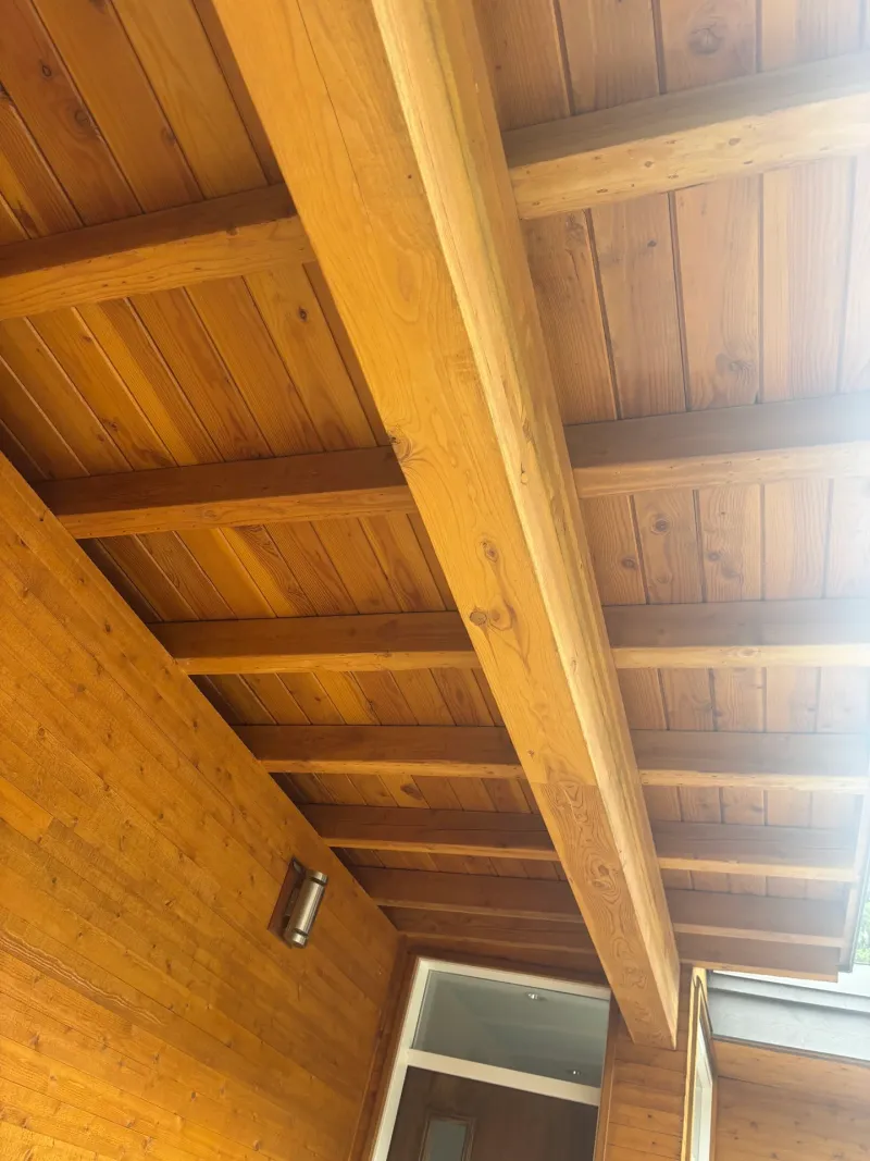 After: Covered porch ceiling with exposed beams and siding wall, . Arbour woods, Squamish, BC