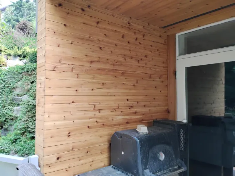 Before: Covered porch corner showing siding walls and a glass door, . Arbour woods, Squamish, BC