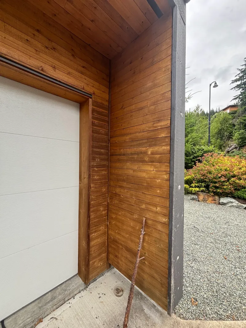 Before: Corner detail of garage door frame and siding column, . Arbour woods, Squamish, BC