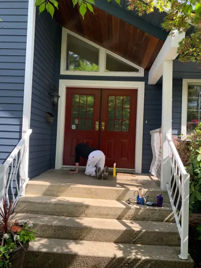 After: Painter doing final detail work at front door, Brackendale Squamish BC