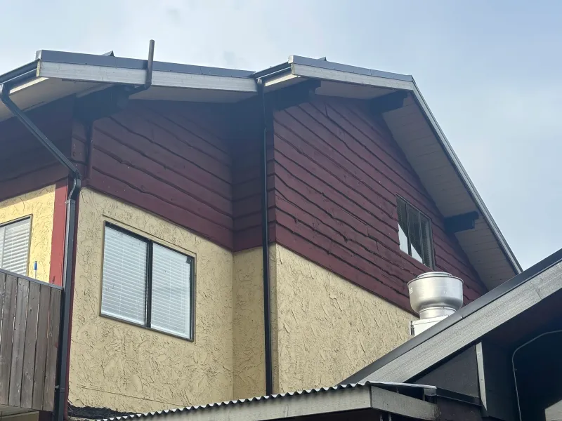 Before: Upper gable corner showing dark siding over wall with a window, Brackendale, Squamish, BC