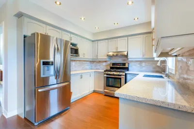 Light grey painted cabinets with stainless steel appliances