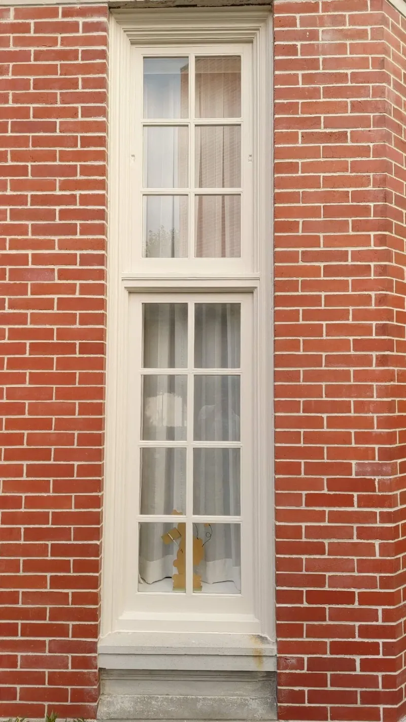 After: Tall narrow window with freshly painted trim set between piers, Central - Granville St, Vancouver, BC