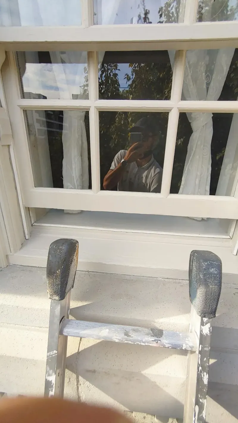 After: Freshly painted window sill and sash with ladder in front, Central - Granville St, Vancouver, BC