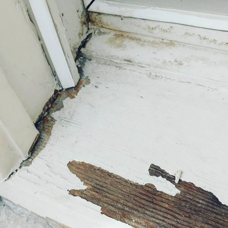 Before: Close view of a window sill corner with peeling paint and rot before repair, Central - Granville St, Vancouver, BC