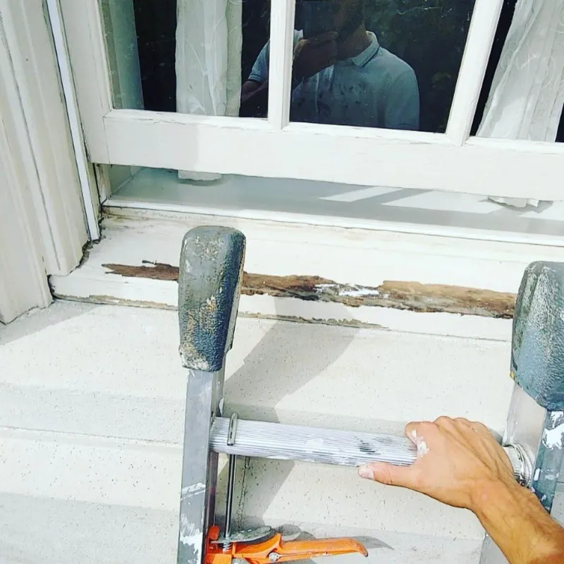 Before: Close view of a damaged window sill before repair, Central - Granville St, Vancouver, BC