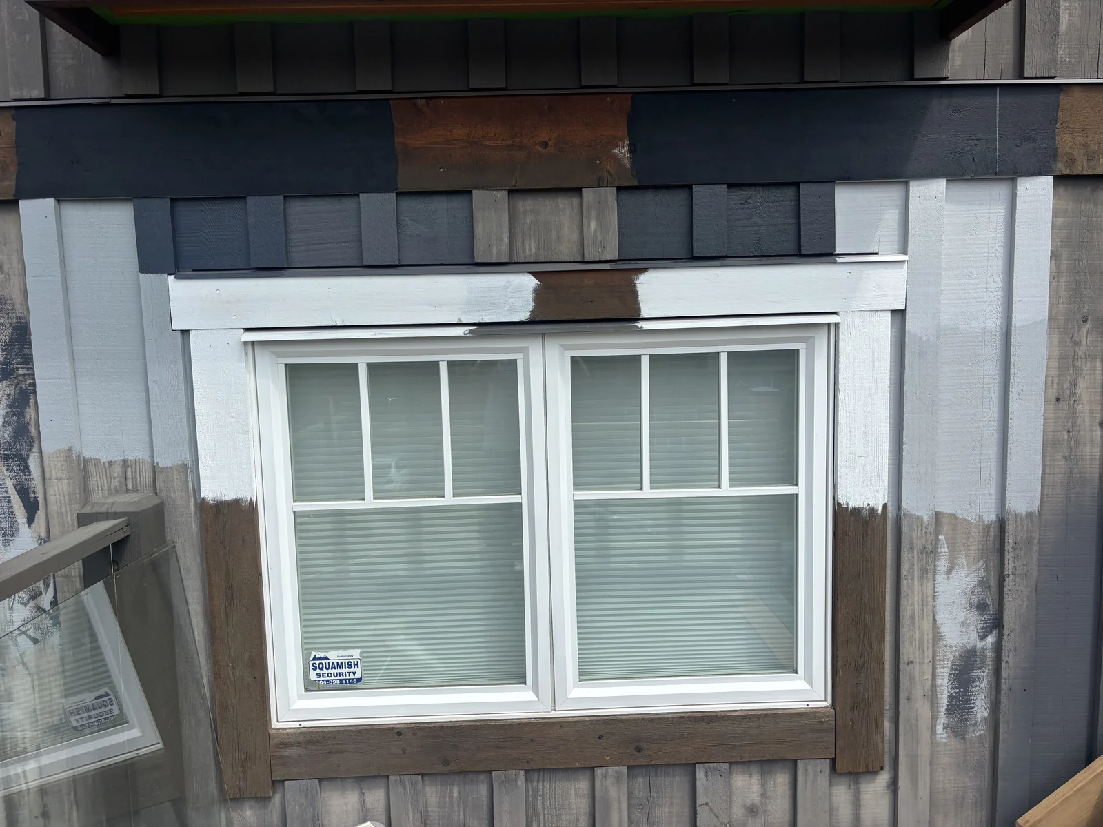 Colour Craft painter applying exterior paint samples before a homeowner commits to a colour
