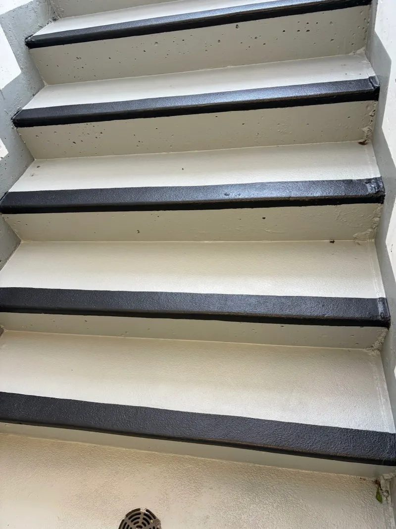 After: Close view of freshly painted stair treads with light surface and black nosing, Downtown BC, Squamish, BC