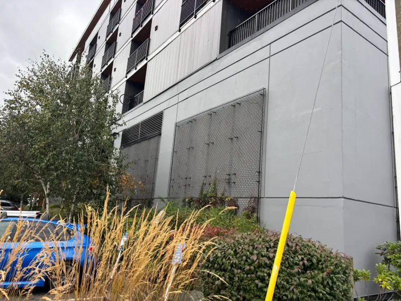 After: Side elevation of freshly painted building wall with screen, Downtown, Squamish, BC