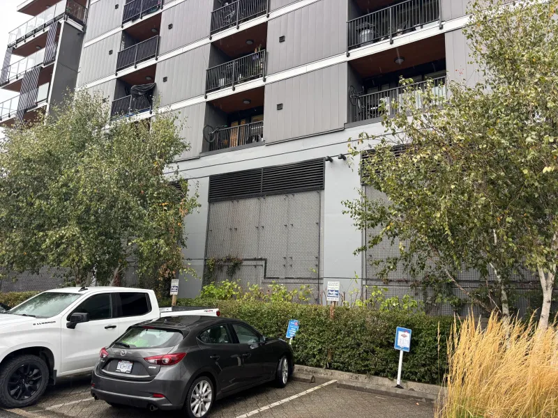 After: Wide view of freshly painted front elevation above parking area, Downtown, Squamish, BC