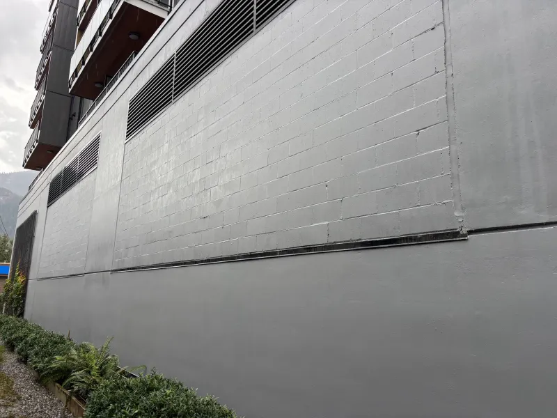 After: Close-up angled view of freshly painted block wall near vents, Downtown, Squamish, BC