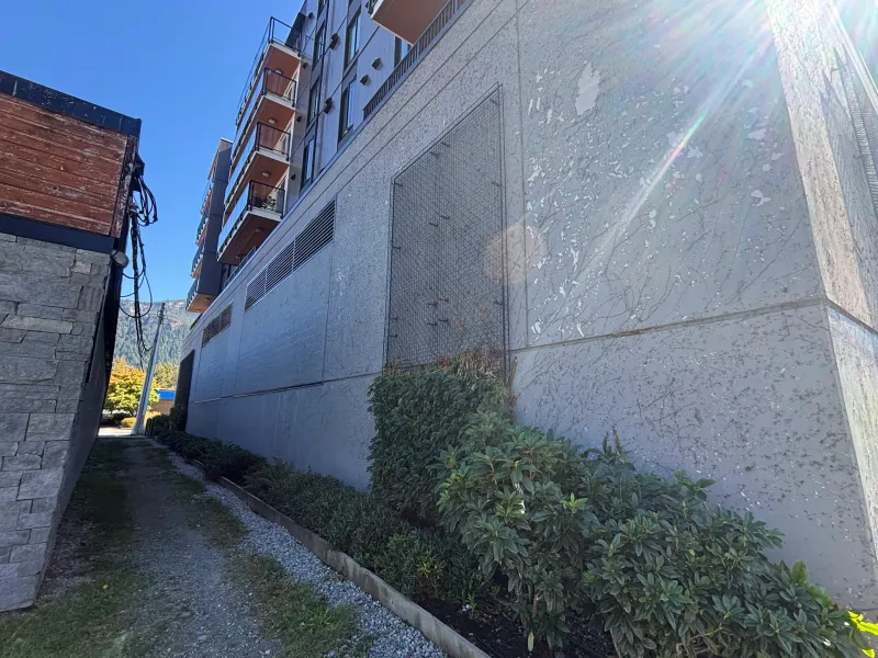 Before: Side elevation wall along walkway with protective screen, Downtown, Squamish, BC