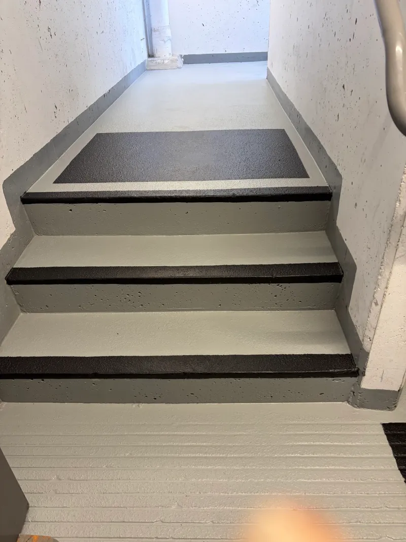 After: Freshly coated stair landing and steps with clean gray and black nonslip finish, Downtown, Squamish, BC