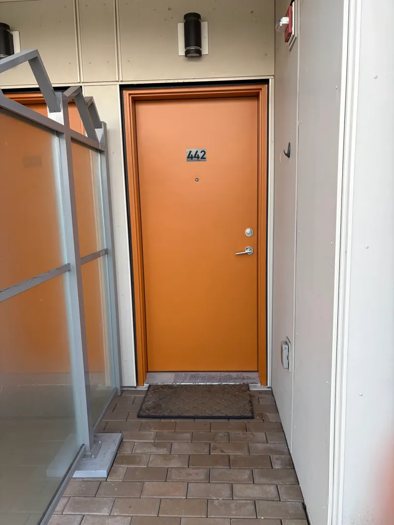After: Entry door painted bright orange with matching trim, glass canopy, and look walkway, Downtown, Squamish, BC