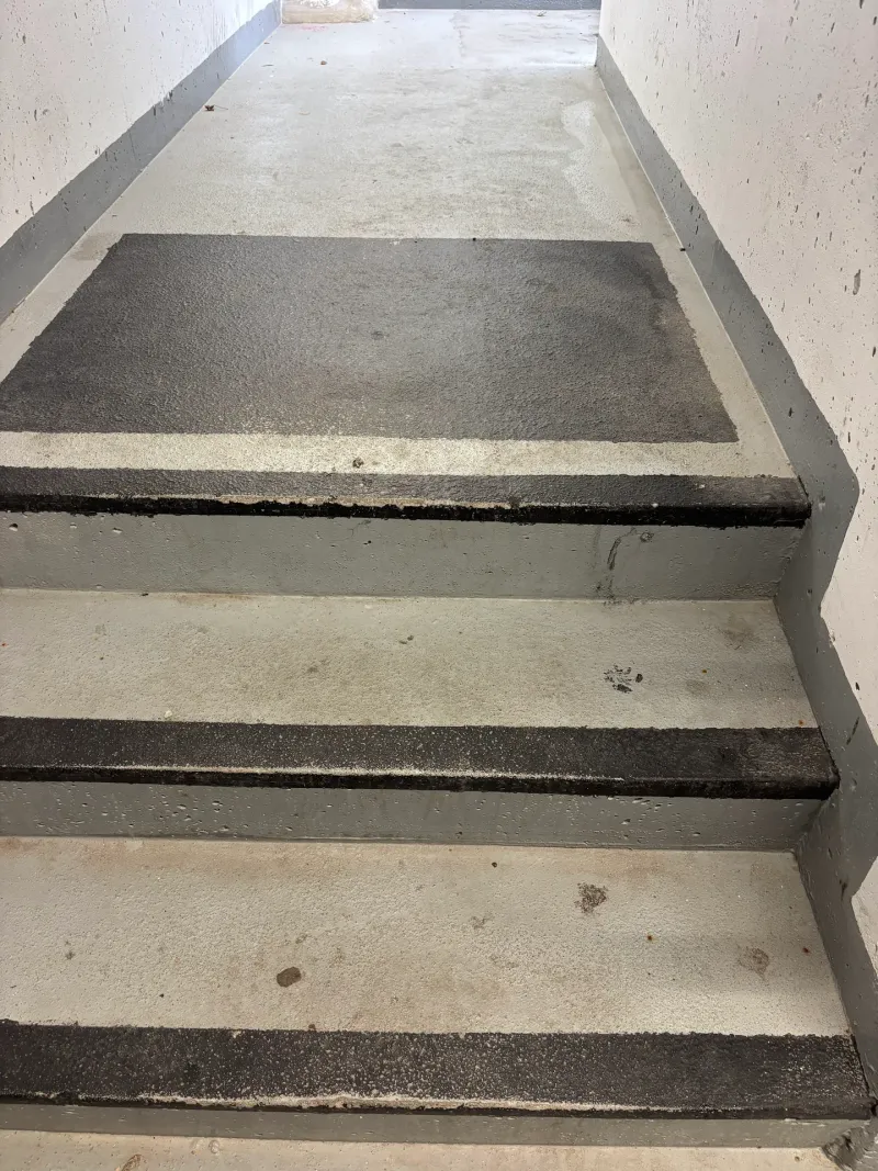 Before: Worn concrete stair landing and steps with dark staining before refinishing, Downtown, Squamish, BC