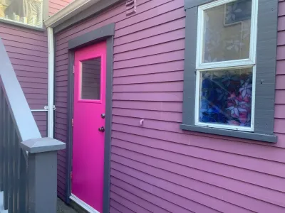 After: Purple siding and pink door detail, East Vancouver