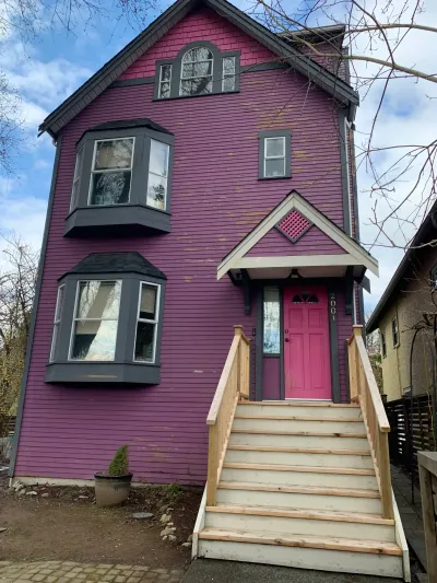 Before: 3-storey East Vancouver home with peeling purple siding and pink door