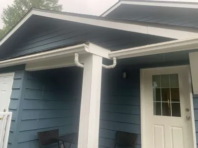 After: porch with white gutters and blue siding, Garibaldi Highlands Squamish