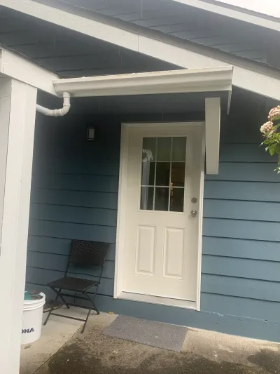 After: back entry door, white with blue siding, Garibaldi Highlands Squamish BC