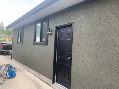 After: corner detail, grey stucco
