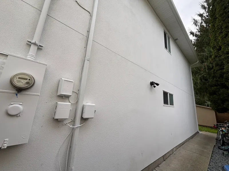 After: Side elevation of a house with two small windows and a plain wall surface, Garibaldi highlands, Squamish, BC