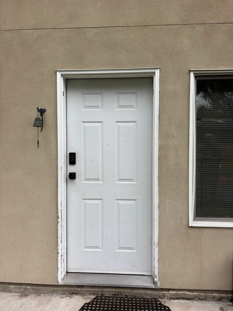 Before: Close view of a white paneled side door with a window beside it, Garibaldi highlands, Squamish, BC