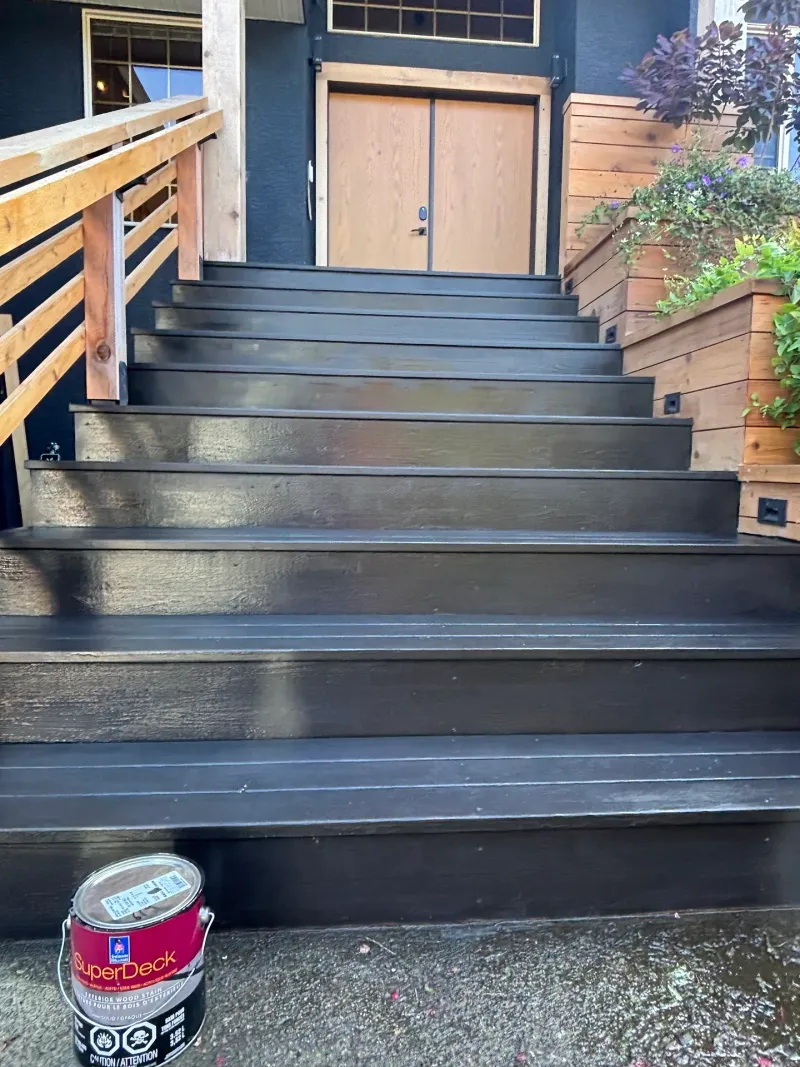 After: Front staircase with dark painted treads and risers leading up to the entry door, railings and planters alongside, Highlands, Squamish, BC