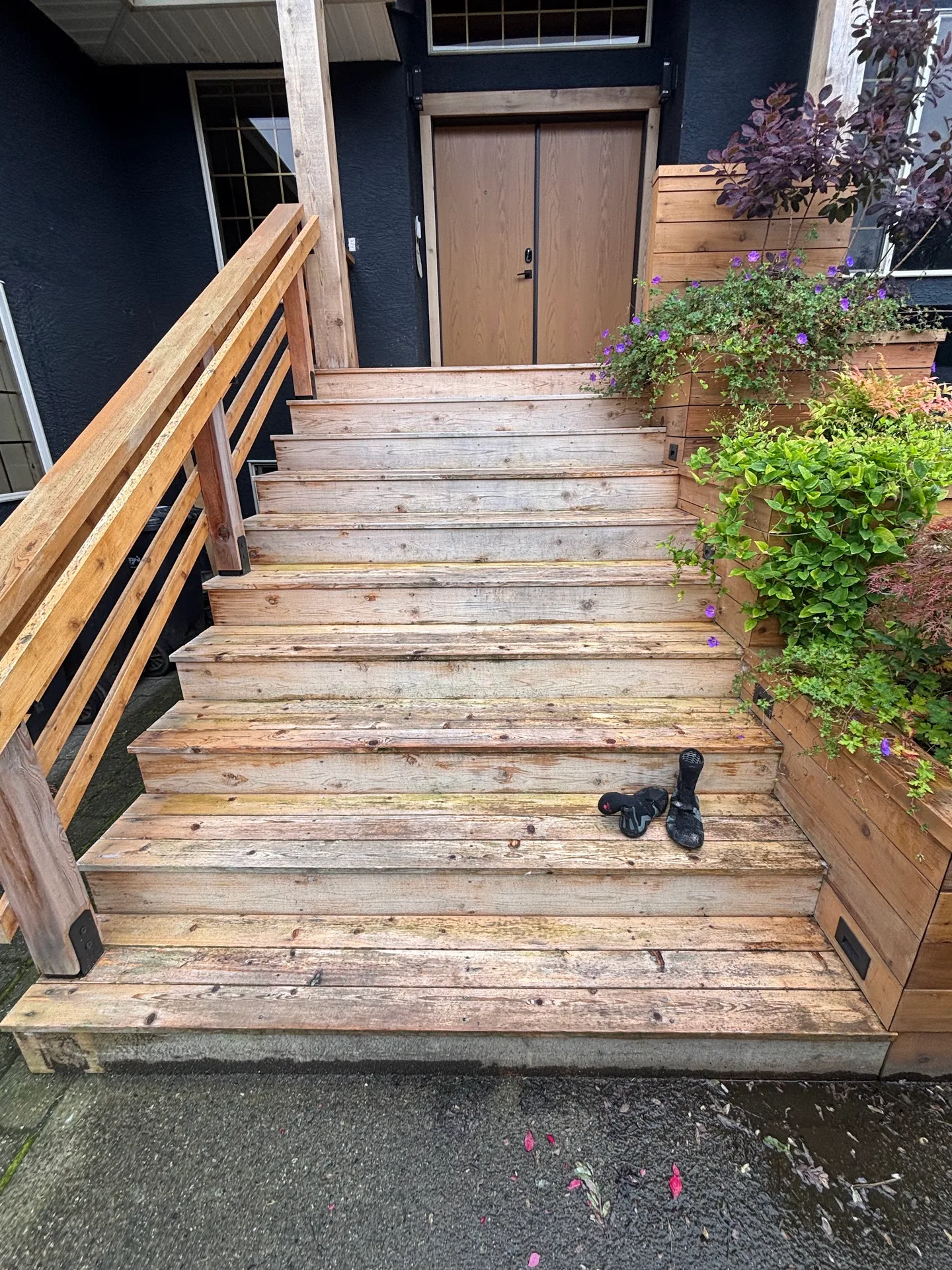 Before: front entry staircase with unpainted treads and risers leading down from the front door, flanked by railings and planter boxes, Highlands, Squamish, BC