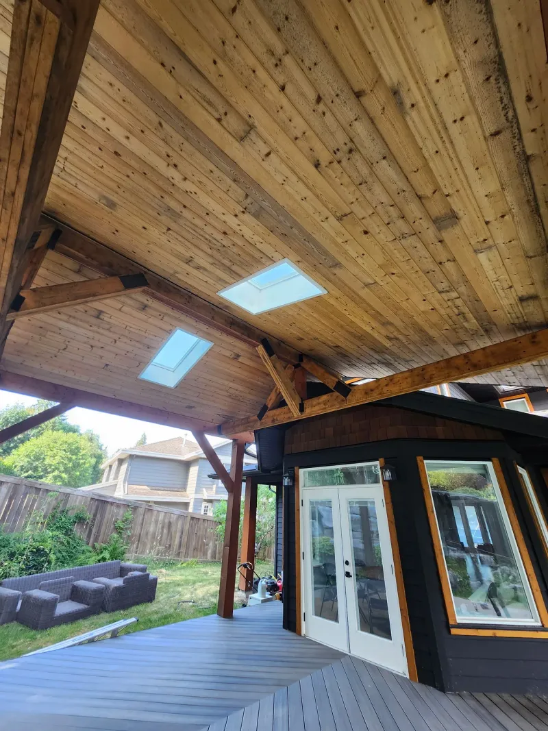 Before: Underside of a covered patio roof with exposed ceiling and beams above a rear patio door, - Isabella Rd, Salt Spring Island, BC