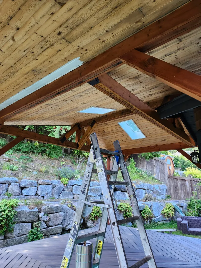 Before: ceiling and beams of a covered patio with two skylights, - Isabella Rd, Salt Spring Island, BC