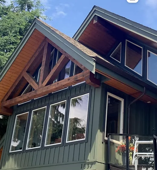 After: Gable with restored dark-stained beams and fresh green solid stain siding, Garibaldi Highlands