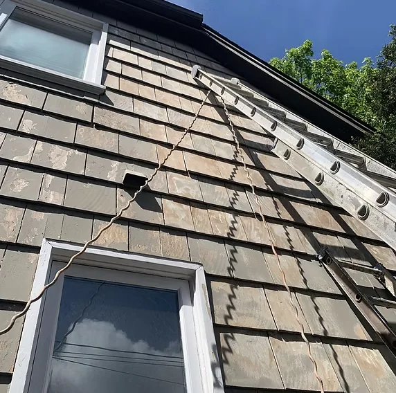 Before: Cedar shingles with ladder, showing extent of weathering, Garibaldi Highlands