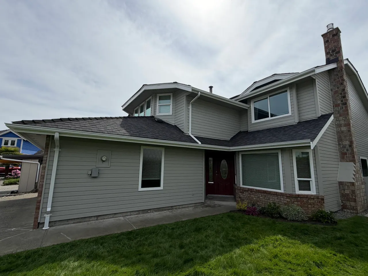 After: Repainted front entry with siding, bay window, red door and covered walkway, Richmond, BC