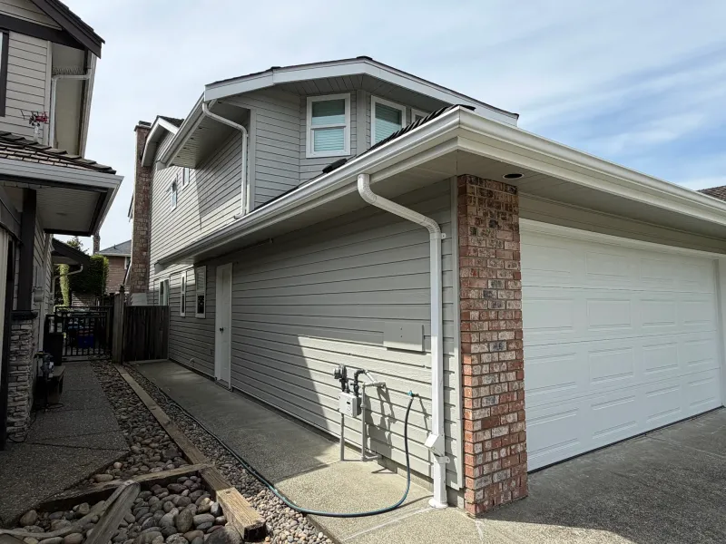 After: Side elevation showing garage wall, pillar and gable above pathway, Richmond, BC