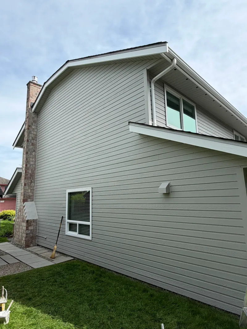 After: Side elevation showing gable, chimney and window above patio area, Richmond, BC