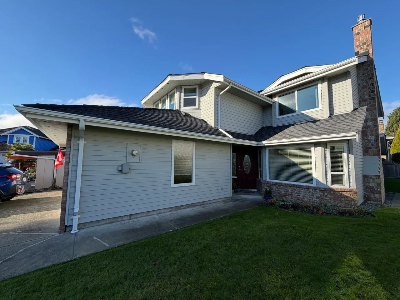 Before: Front entry with siding, bay window and covered walkway leading to door, Richmond, BC