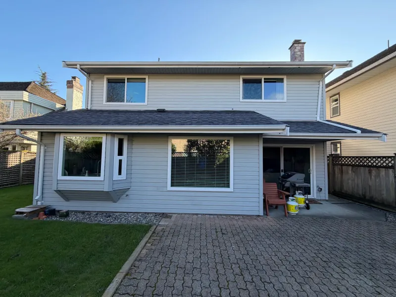 Before: Rear elevation with large windows, sliding door and covered patio area, Richmond, BC