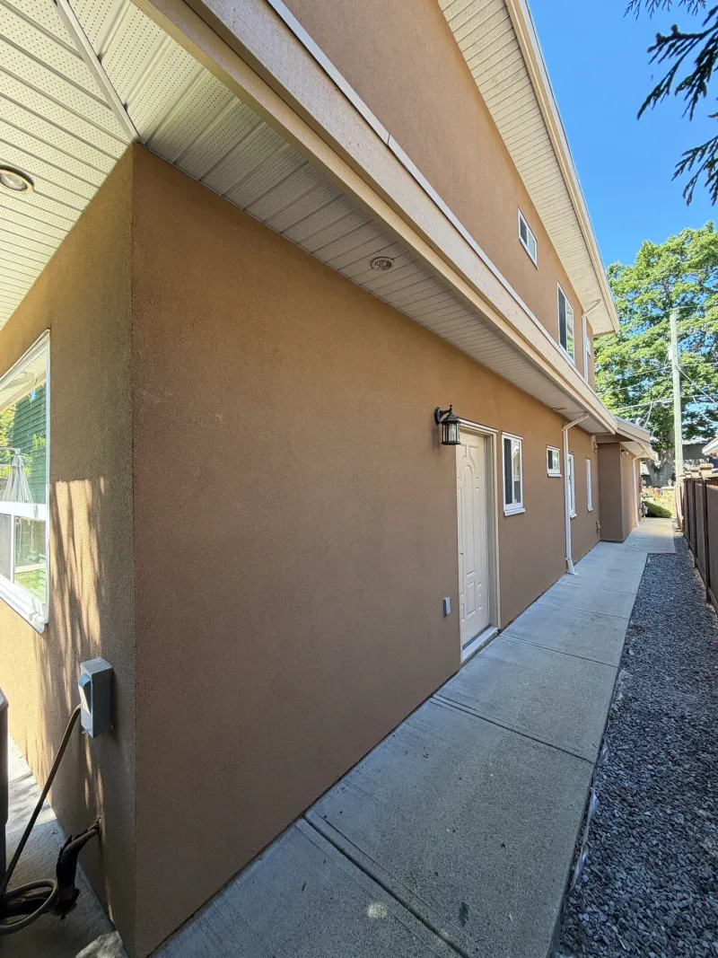 After: Side elevation of house with door, window, eaves and gravel walkway, Seafair, Richmond, BC