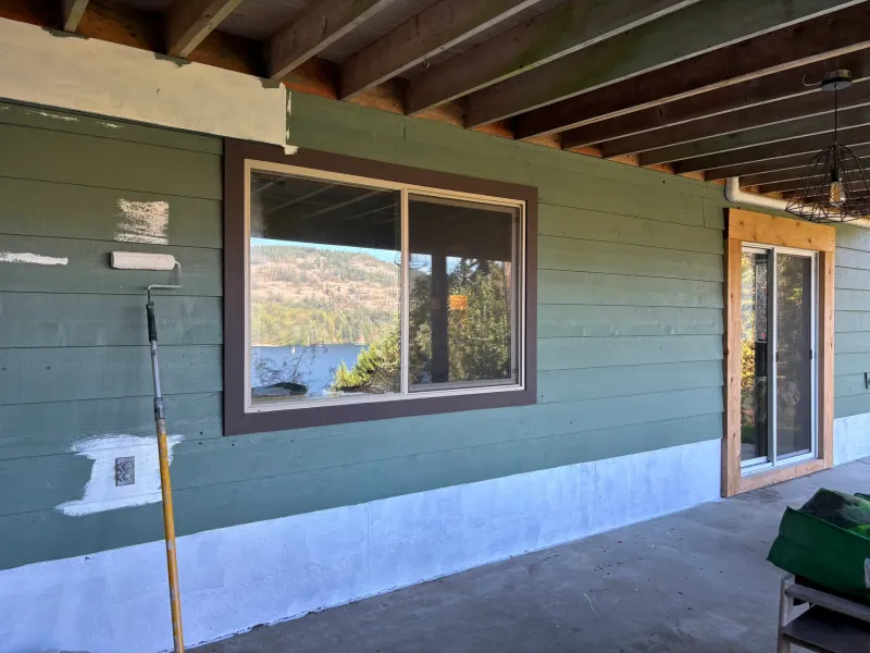 Before: Section of house wall with window, partially painted siding and trim, Souther Salt Spring. Isabella Point / Roland Rd, BC