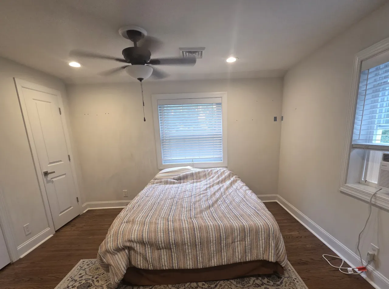 Before: Bedroom with white walls, closet door, ceiling fan, and window before repainting, Springfield, PA