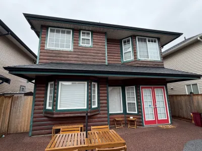 Before front exterior view of log siding and stone facade in Steveston Richmond BC