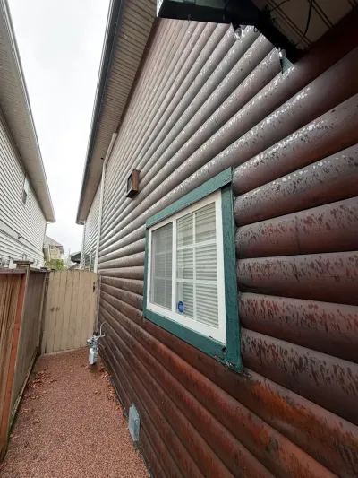 Before exterior detail of weathered log siding and window trim in Steveston Richmond BC