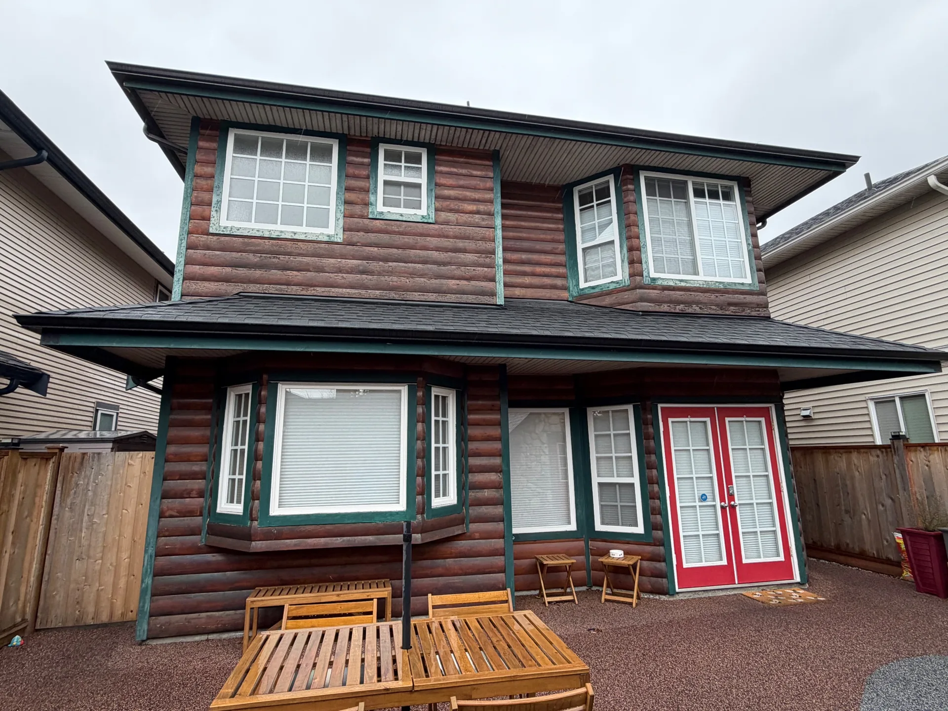 Before: Rear elevation with log siding, bay windows and red French doors, Steveston, Richmond, BC