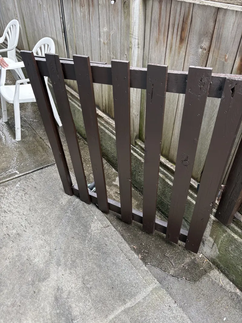 Wooden garden gate repainted in the brown colour-match finish at the Steveston home in Richmond, BC