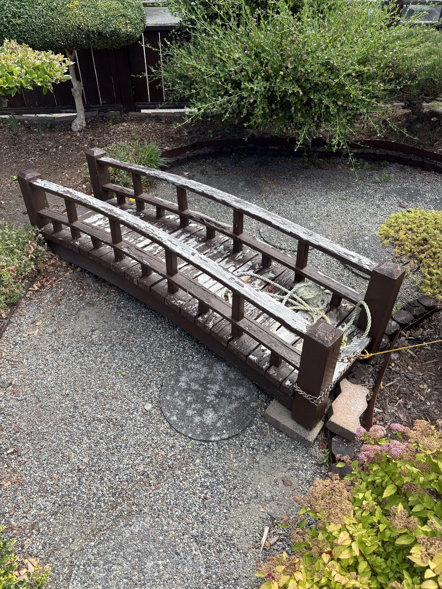 Weathered garden footbridge with peeling finish before the brown colour-match refresh at a Steveston home in Richmond, BC