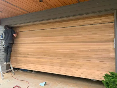 Before: Cedar garage door being stained, Squamish BC wood restoration