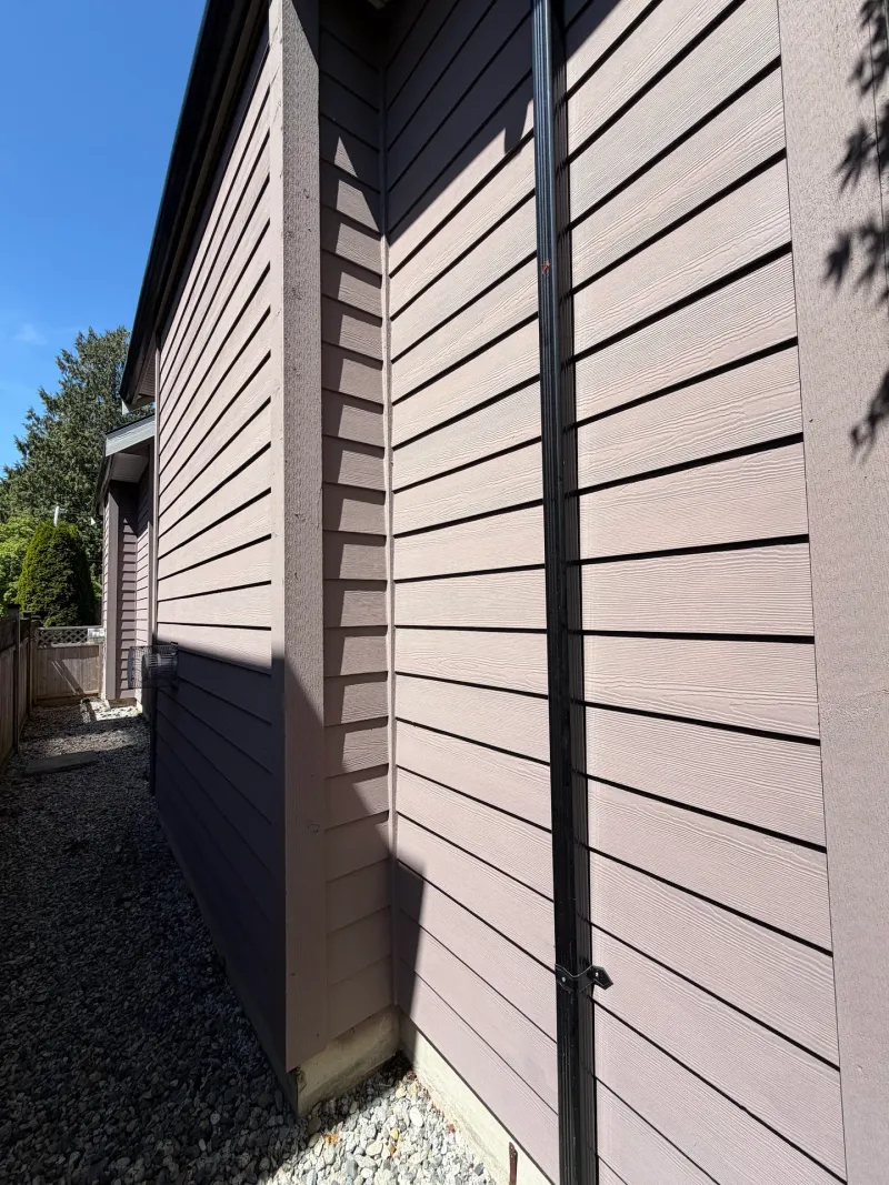 After: Close view of painted side wall corner and downspout under covered eave, Tsawwassen, Delta, BC